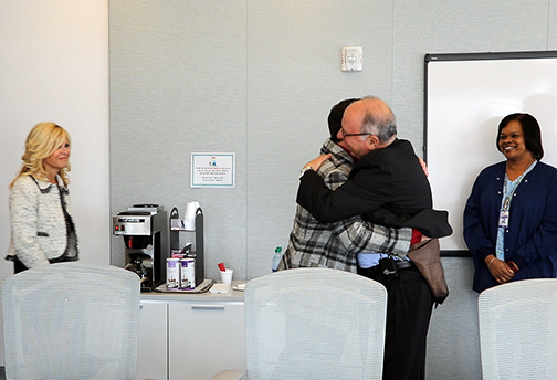 Al Copeland, Jr and Dr. Alfonso Vargas hug as Liz Copeland looks on